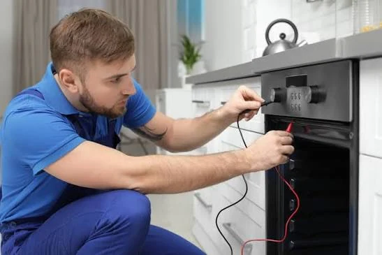 Technician checking an oven with diagnostic meter probes
